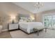 Primary bedroom with large bed and water views at 3491 Byron Ln, Longboat Key, FL 34228