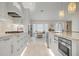 Modern kitchen with white cabinets and stainless steel appliances at 3491 Byron Ln, Longboat Key, FL 34228