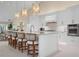 Modern kitchen with white cabinets, large island, and breakfast bar at 3491 Byron Ln, Longboat Key, FL 34228