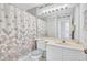 Clean bathroom with seashell shower curtain and vanity at 4202 Caddie E Dr # 202, Bradenton, FL 34203