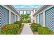 Community walkway with lush landscaping and building exteriors at 4202 Caddie E Dr # 202, Bradenton, FL 34203