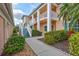 Condo building exterior with walkway and landscaping at 4202 Caddie E Dr # 202, Bradenton, FL 34203