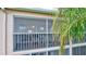 Screened lanai with patio furniture and view of trees at 4202 Caddie E Dr # 202, Bradenton, FL 34203