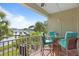 Cozy balcony with ample seating offers beautiful views of the surrounding lush landscaping and harbor at 423 Bahia Beach Blvd, Ruskin, FL 33570