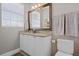 Bathroom with granite countertop, white cabinets and large mirror at 423 Bahia Beach Blvd, Ruskin, FL 33570