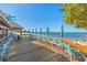 Outdoor bar deck with ocean views, umbrellas, and turquoise chairs at 423 Bahia Beach Blvd, Ruskin, FL 33570