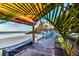 Beachfront deck dining area with tables, chairs, and ocean views at 423 Bahia Beach Blvd, Ruskin, FL 33570