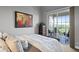 Bright bedroom with sliding doors to balcony and artwork at 423 Bahia Beach Blvd, Ruskin, FL 33570