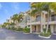 Condo building with parking and tropical landscaping at 423 Bahia Beach Blvd, Ruskin, FL 33570