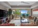 Cozy living room with sliding glass doors that open to a scenic balcony overlooking the water at 423 Bahia Beach Blvd, Ruskin, FL 33570