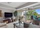 Inviting living room with a sliding glass door leading to a balcony with a view of lush greenery at 423 Bahia Beach Blvd, Ruskin, FL 33570