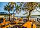 Outdoor seating area with picnic tables, waterfront views, and palm trees at 423 Bahia Beach Blvd, Ruskin, FL 33570