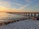 Picturesque view of a wooden pier extending into the calm water at sunset at 423 Bahia Beach Blvd, Ruskin, FL 33570