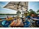 Waterfront deck with tables, chairs, and umbrellas, offering water views at 423 Bahia Beach Blvd, Ruskin, FL 33570