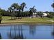 Golf course view with palm trees and pond at 4440 Fairways Blvd # 206, Bradenton, FL 34209