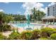 Community swimming pool with lounge chairs and umbrellas at 4440 Fairways Blvd # 206, Bradenton, FL 34209