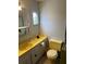 Bathroom with yellow vanity and toilet at 4509 10Th Street E Ct, Ellenton, FL 34222