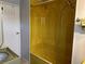 Retro yellow bathroom with shower/tub combo and vintage fixtures at 4509 10Th Street E Ct, Ellenton, FL 34222