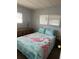 Bedroom with double bed and flamingo bedding at 4509 10Th Street E Ct, Ellenton, FL 34222