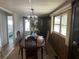 Bright dining room with a chandelier, wood table and chairs, and a view into another room at 4509 10Th Street E Ct, Ellenton, FL 34222