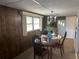 Charming dining room features a wood table and chairs, a chandelier and wood wall paneling at 4509 10Th Street E Ct, Ellenton, FL 34222