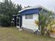 White and blue mobile home with covered porch and side yard at 4509 10Th Street E Ct, Ellenton, FL 34222