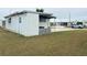 Single-wide mobile home with side yard and concrete pad at 4509 10Th Street E Ct, Ellenton, FL 34222