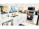 Modern white kitchen with stainless steel appliances at 4629 Kingsmere # 20, Sarasota, FL 34235