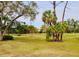 Landscaped backyard with mature trees and lush greenery at 4629 Kingsmere # 20, Sarasota, FL 34235