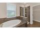 Bathroom with an oval soaking tub and walk-in shower at 4711 Garden Arbor Way, Bradenton, FL 34203