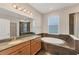 Bathroom with soaking tub, walk-in shower, and granite vanity at 4711 Garden Arbor Way, Bradenton, FL 34203