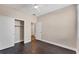 Bedroom with double door closet and dark floors at 4711 Garden Arbor Way, Bradenton, FL 34203