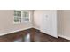 Bedroom with two windows, built-in cabinets and dark tile flooring at 4711 Garden Arbor Way, Bradenton, FL 34203