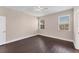 Well-lit bedroom with dark floors and large windows at 4711 Garden Arbor Way, Bradenton, FL 34203