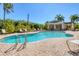 Community pool with lounge chairs and covered patio at 4711 Garden Arbor Way, Bradenton, FL 34203