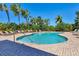 Community pool with lounge chairs and palm trees at 4711 Garden Arbor Way, Bradenton, FL 34203