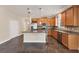 Modern kitchen with wood cabinets and granite countertops at 4711 Garden Arbor Way, Bradenton, FL 34203