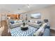 Living room with staged furniture and large windows at 4711 Garden Arbor Way, Bradenton, FL 34203