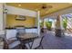 Outdoor kitchen with seating area, under covered patio at 4711 Garden Arbor Way, Bradenton, FL 34203