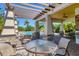 Covered patio area with tables and chairs near the pool at 4711 Garden Arbor Way, Bradenton, FL 34203