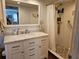 Bright bathroom features a marble countertop vanity and walk-in shower with pebble floor at 4900 38Th S Way # 201, St Petersburg, FL 33711