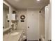 Bathroom with single vanity, white door and shower, decor, and tiled floors at 4900 38Th S Way # 201, St Petersburg, FL 33711