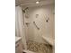 Walk-in shower features stone floor, grab bar, and tiled walls at 4900 38Th S Way # 201, St Petersburg, FL 33711