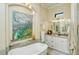 Spa-like bathroom featuring a soaking tub, walk-in shower, and modern vanity at 5118 Chateau Ct, Sarasota, FL 34238