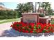 Elegant community entrance with red flowers and fountain at 5118 Chateau Ct, Sarasota, FL 34238