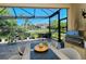 Enclosed patio with lake view and outdoor dining area at 5118 Chateau Ct, Sarasota, FL 34238