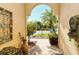 Elegant entryway with arched opening, iron accents, and courtyard view at 5118 Chateau Ct, Sarasota, FL 34238