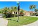 House exterior showing street view and lush landscaping at 5118 Chateau Ct, Sarasota, FL 34238