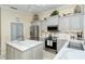 Modern kitchen featuring stainless steel appliances and a large island at 5118 Chateau Ct, Sarasota, FL 34238