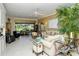 Living room with large windows, neutral colors, and comfortable seating at 5118 Chateau Ct, Sarasota, FL 34238